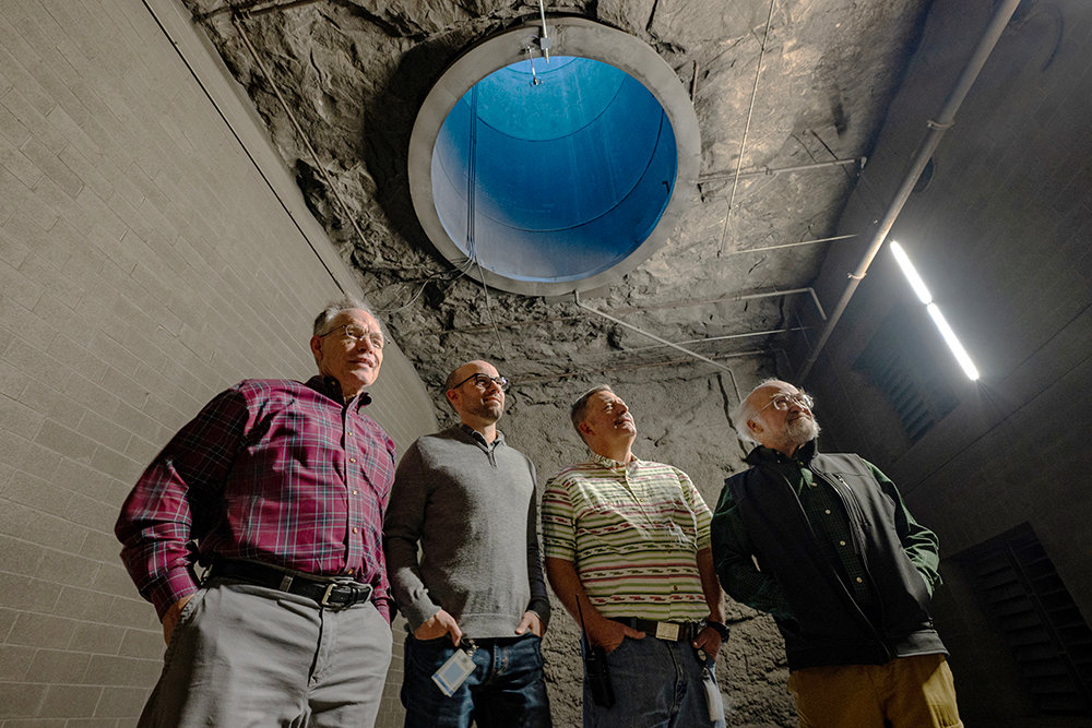 Bluebird Underground's Todd Murren and Greg Cantrell, first and third from left, stand with John and Mike Chiles beneath an air shaft that is the source of warm air generated by Bluebird's data center to Hope's Garden, a greenhouse being developed, co-founded by the Chileses.